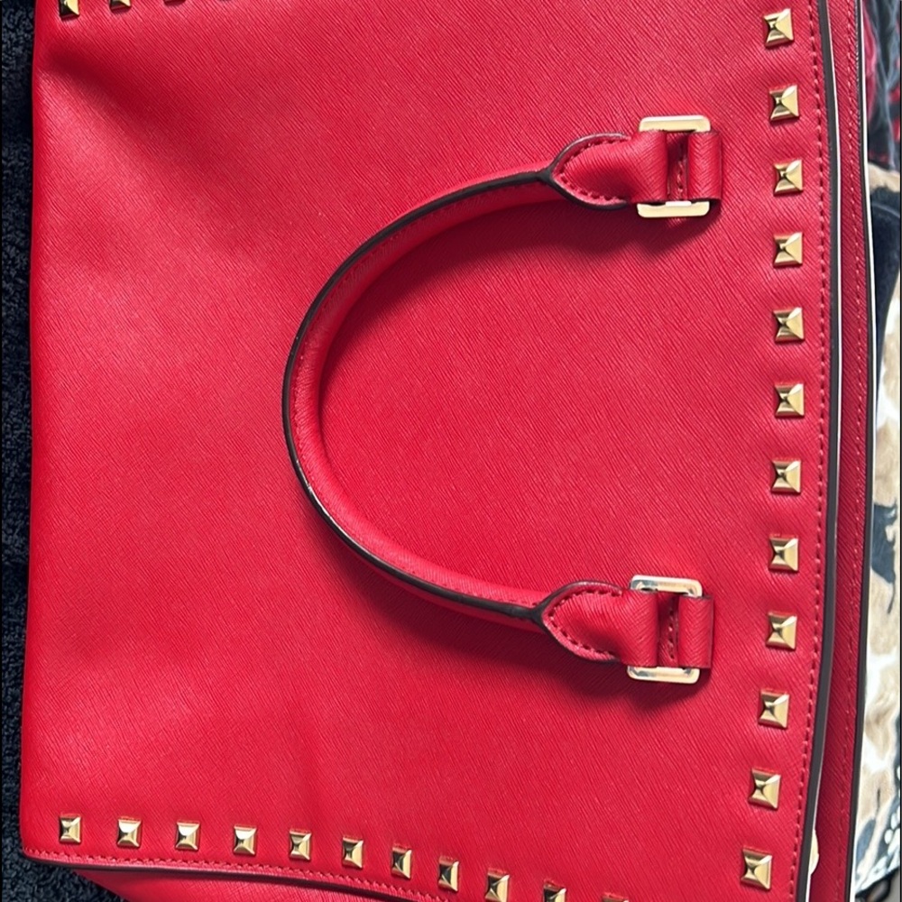 Michael Kors satchel Ruby red with gold accents. Brand new condition. Beautiful